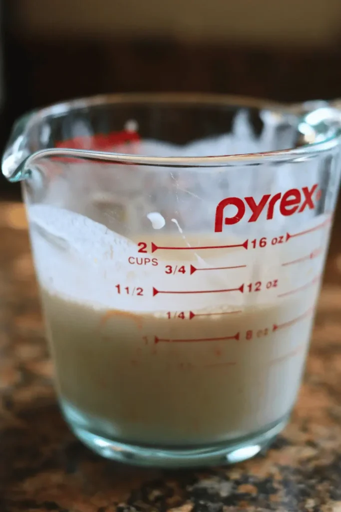 In a liquid measuring cup, combine half of the orange zest, orange juice, milk, and sourdough discard. Whisk until completely smooth.