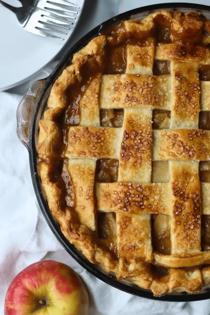 In a small bowl, prepare an egg wash by whisking together an egg with a splash of milk. Use a pastry brush to apply the egg wash over the top of the dough. For an extra touch of sweetness and crunch, sprinkle coarse sugar on top of the pie.