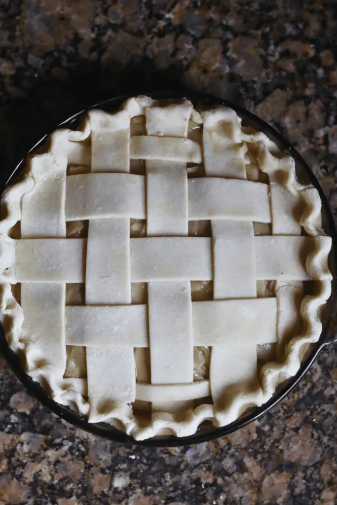After rolling out the dough fully, add more flour to your work surface to prevent sticking. Flip the dough over and roll it out again until it's nice and thin, approximately 1/8 inch thick and shaped into a 12-inch circle.