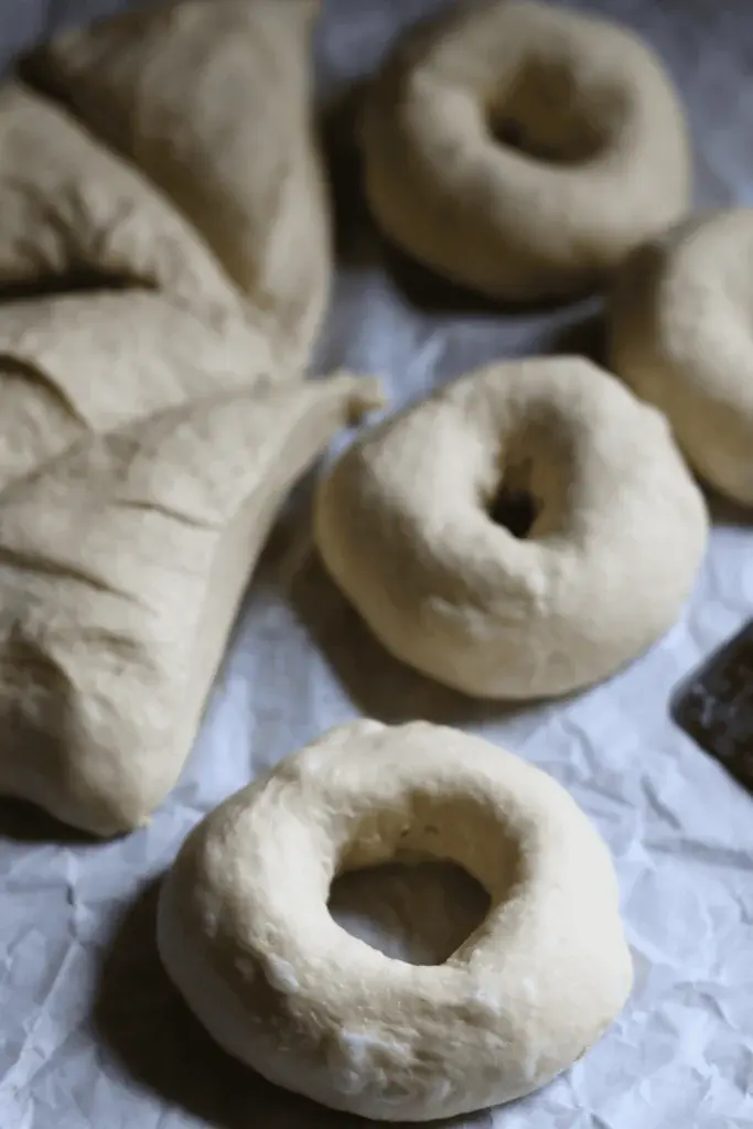 Step 9: Take it slow, and with your thumb, poke a hole right in the center of the dough ball. Then, using both thumbs, stretch that dough ball out to about 2 inches.